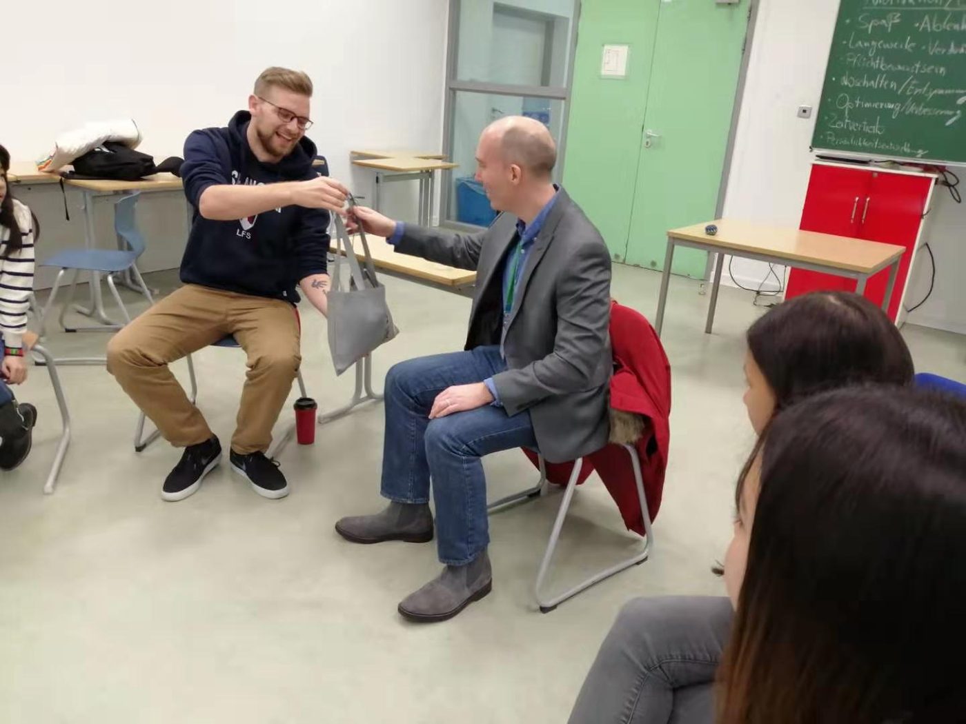 Ryan Scott Ulrich running an interactive workshop exercise with a participant while a group watches